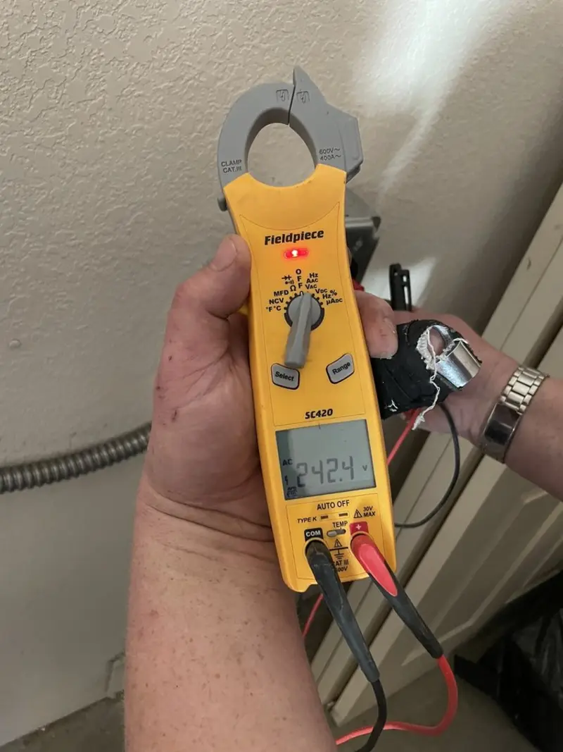 Voltage testing with clamp meter during Ceiling Fan Installation in Wickenburg
